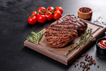 Fresh juicy delicious beef steak on a dark background