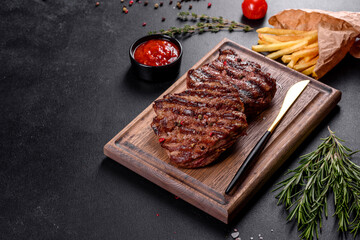 Fresh juicy delicious beef steak on a dark background
