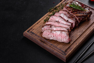 Fresh juicy delicious beef steak on a dark background