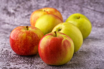 Green and red apples on blackboard or chalkboard background. Close-up on a gray background.Ideal food for diet.