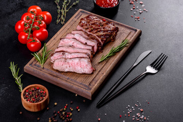 Fresh juicy delicious beef steak on a dark background