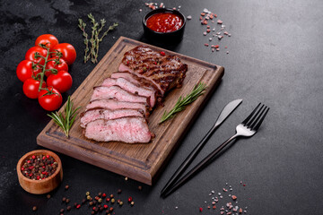 Fresh juicy delicious beef steak on a dark background