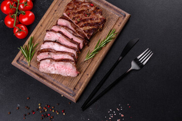 Fresh juicy delicious beef steak on a dark background