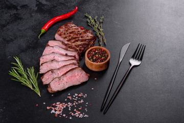 Fresh juicy delicious beef steak on a dark background