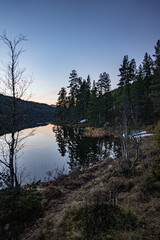 Sunset on a lake with mountains around it