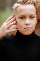 young handsome boy with beautiful blonde woman queen. autumn green forest mystic. Vintage medieval shiny crown. Long evening green dress. magic fantasy