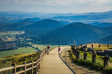 path and view on the Chaine des Puys volcanoes range from the top of the Puy de Dome, the most...