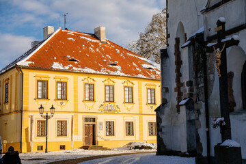 Fototapeta premium Narrow picturesque street with baroque and renaissance historical buildings in winter sunny day, beautiful cityscape of royal medieval town Pisek, Southern Bohemia, Czech Republic