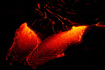 Close up of red hot flowing lava from Kilauea volcano at night