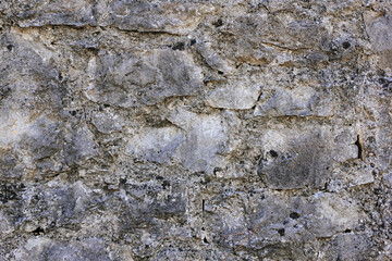 Natural old beige stone wall textured background. Close up. Copy space.