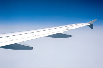 Fototapeta premium View from airborne airplane window at cloudy milky sky at high altitude.