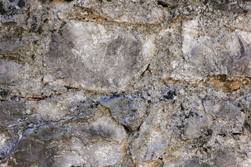 Natural old beige stone wall textured background. Close up. Copy space.