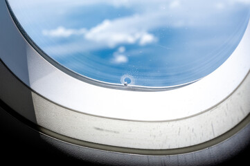 Tiny hole or bleed hole in airplane window compensate for difference between the pressure inside...