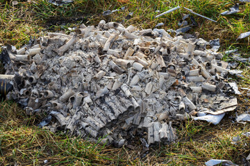Remains of burned and burnt parts of fireworks.