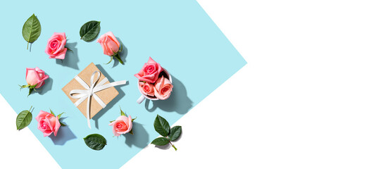 Gift box with pink roses overhead view - flat lay