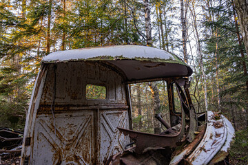 Old cars in wild nature on the car cemetery of Kyrkö Mosse in Sweden