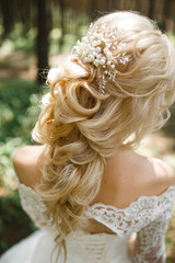 Bride's hairstyle back view. Bride in nature, back view.