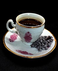 Cup of coffee with small chocolates