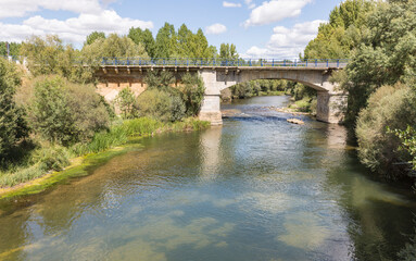 Fototapeta na wymiar Medieval bridge over Porma river in Puente Villarente (Municipality of Villaturiel), province of Leon, Castile and Leon, Spain