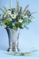bunch of flowers in a  silver vase