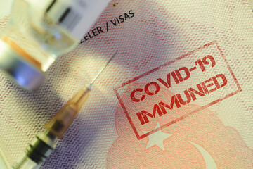Close up shot of a coronavirus vaccine bottle and a syringe with a Turkeys passport as a vaccine...