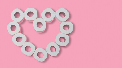 Heart made from rolls of toilet paper on a pink background. Valentines day during pandemic concept