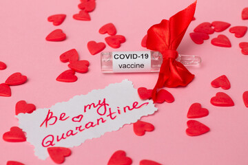 Ampoule with COVID-19 vaccine, gift for Valentine's Day with note Be My Quarantine next to red hearts on pink background