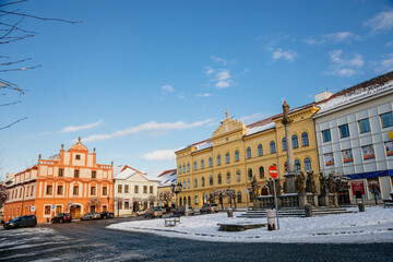 Marian Column, Municipal Library and baroque and renaissance historical buildings at Alsovo Square in winter sunny day, royal medieval town Pisek, Southern Bohemia, Czech Republic