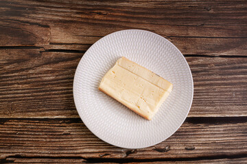 Plain raclette cheese in a white plate