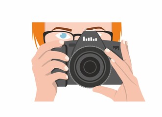 A girl photographer with orange hair, blue eyes holds a black camera and looks forward. Vector drawing of a woman photojournalist on a white background