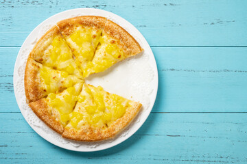 fresh pizza with fruit toppings with one piece missed