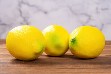 side view artificial lemons on a wood table
