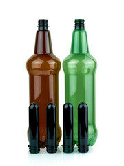 Plastic bottles and PET preforms. Manufacturing of plastic PET bottles. Brown and green plastic bottle on white background.