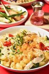 Macaroni with chicken,cauliflower and broccoli on plate.