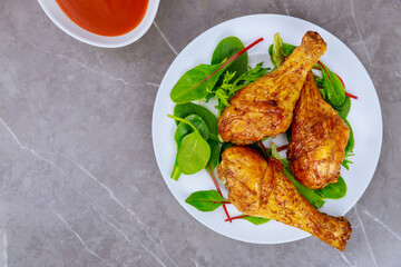 Grilled chicken drumsticks marinated with buffalo sauce.