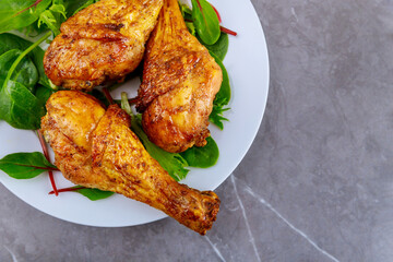 Grilled chicken drumsticks marinated with buffalo sauce.