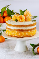 Fresh mandarin sponge cake decorated with tangerines.