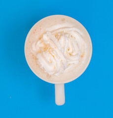 vanilla cream latte in a white cup from top