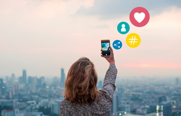 Woman taking a photo of the sunset