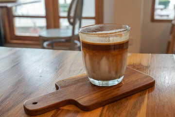 iced dirty coffee menu served in glass on wooden table in cafe