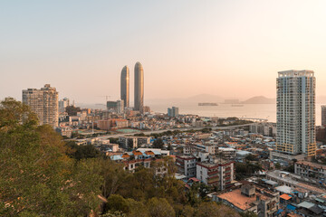 Fototapeta premium Xiamen city skyline with modern buildings, old town and sea at dusk