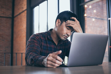 depression serious people from work,study stress concept.asian man feeling tired suffering using computer working work place.concept global economic,health problems