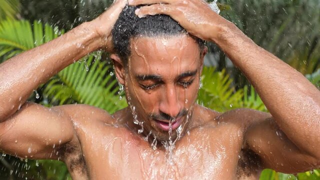 Portrait Of A Sexy Young Black Man Taking Shower Outdoor On A Summer Day.