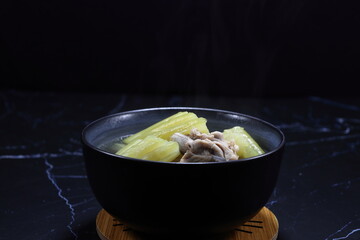 Classic clear soup of fresh bitter gourd with chicken serving in the bowl. Famous hot soup menu in Asia restaurant. 