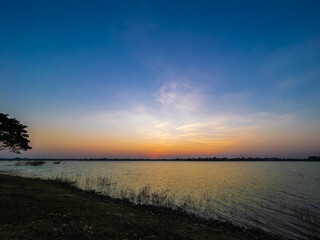 The sky at sunset, twilight colors beautifully with river or lake. Natural background