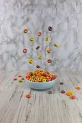 Colorful levitating fruity breakfast cereal.