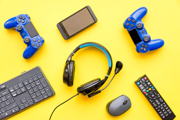Modern toys - gaming controller, headphones, tv remote control, smart phone and computer keypad and...