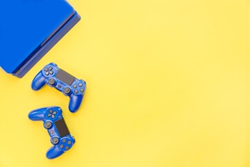 Top view of blue gaming controllers and console. Virtual regality gaming accessories.