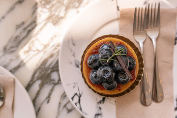 Blueberry cake on the marble table. Dessert.