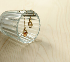 Close up golden earrings with crystals, beautiful crystal earrings , women accessories